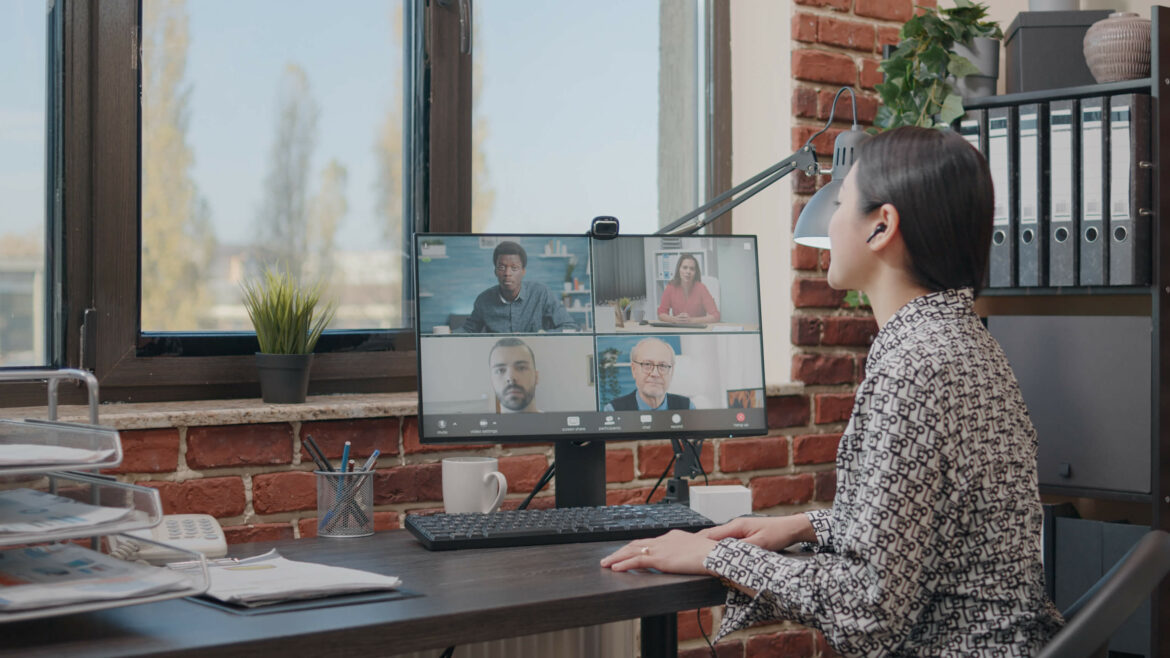 a woman hosting hybrid events with virtual attendees for an internal company meeting