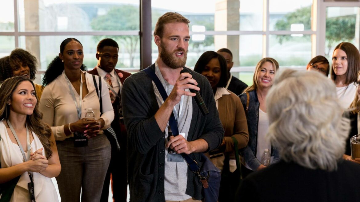 an in person audience asks a question during a successful hybrid event