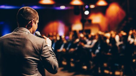 man giving speech at hybrid event